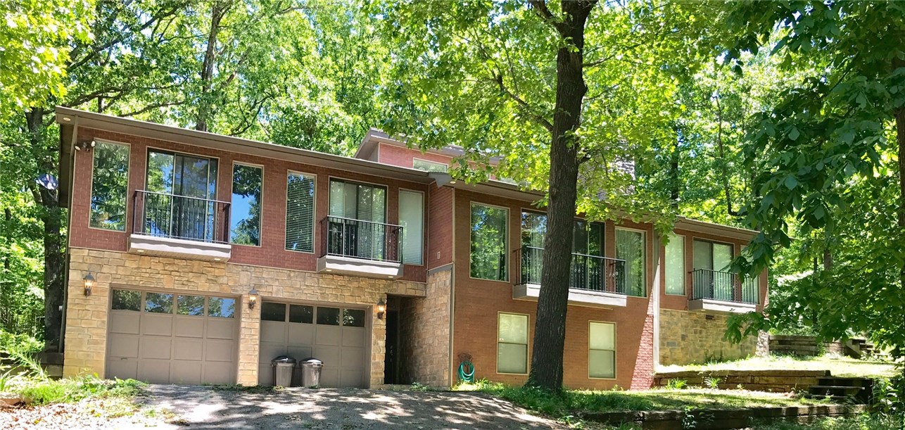 Beautiful split level home on 1.75 wooded acres. 4 bedrooms, 3 baths, approx. 2,600 heated sq ft. Conveniently located off Hwy 71, just minutes from downtown Fayetteville .Close to I-49 access, . City close yet country quiet. . Amenities: fireplace with wood stove insert, mud room, new carpet and manufactured wood flooring in 2015, Vaulted ceiling in kitchen and living room, new interior paint, stainless appliances, downstairs 2nd master suite, over sized 2 car garage, carport , covered back patio,