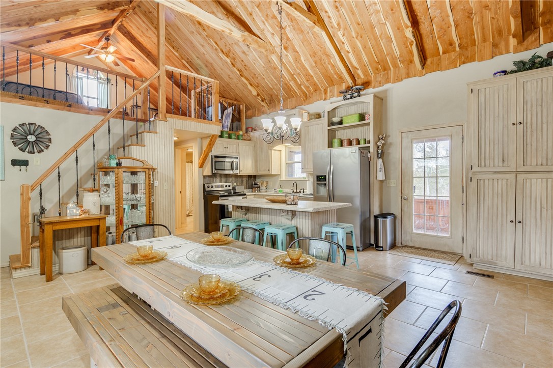 Cute home on almost 5 acres with an AMAZING view! Living room has bead-board wood ceiling, wood stove, built-ins, 2 full size storage closets, and wood floors. Beautiful kitchen has soaring vaulted cedar ceilings - all cedar was milled on property, stainless steel appliances, island, ample storage, and eat-in space. Master has bead-board ceiling, his & hers closets, and access to a small private deck with amazing views! Bathroom has single vanity, heated towel rack, tub/shower combo, with laundry just off the bath. Great space in the upstairs loft. Sit out in the screened-in porch just off the kitchen and enjoy the views. 50x50 fenced garden with established strawberry & rhubarb patches. Chicken coop on property but never any smell from it. Cellphone booster works on all providers. Covered front porch. Metal roof. Newer dishwasher 1 year ago. Detached 3 car garage. Come fall in love with this amazing home & property! It will not disappoint!
