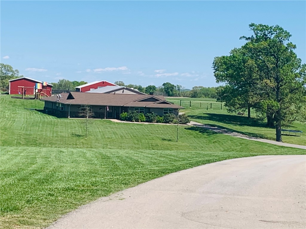 Perfect family home that sits on 3.64 beautiful acres! Very open living area with a large bonus room just off the huge living room that can be used for a play room, exercise room or office. Live in the best of both worlds! Be close to town while also enjoying the private home with peaceful and relaxing views and land. 3 car garage plus a 30X50 shop. Granite countertops throughout. Custom kitchen cabinets with pull out drawers behind doors. Large walk in pantry, mud room, several built in cabinets throughout home, Hardwood flooring and more. Includes a large chicken coop next to raised bed gardens! Great location close to all NWA has to offer. Great area for biking and close to the back 40 trails. The home is set off from the road to give you the privacy you have been looking for.