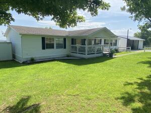 Nice view for this 3 BR, 2 BA, manufactured home on a paved road with a 35 x 28 carport/workshop, storm shelter, 10 x 16 covered deck, 8 x 12 storage building, and 12 x 40 back deck. The .74 of an acre has landscaping and is mostly fenced. Wood fireplace.