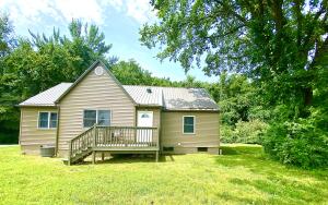 This beautifully remodeled 3-bedroom home in Harrison offers seclusion in a beautiful half acre setting while being right in the middle of town! Upgrades include a modern metal roof, pristine flooring, and fresh exterior vinyl siding. Inside, attention has been given to every detail, with new trim, paint, and a tastefully remodeled kitchen and bathroom. Positioned on a scenic hill, surrounded by majestic trees, the property offers a private and serene atmosphere while remaining conveniently located within minutes of shopping, dining, and entertainment. Don't miss out on this rare opportunity. Make it yours today!