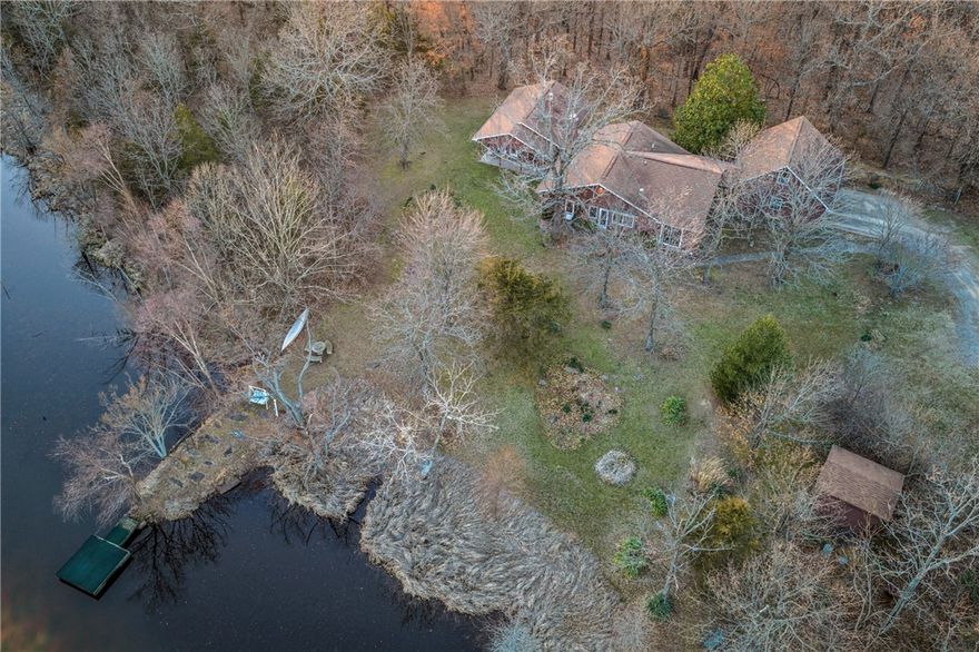 This Charming 3 BR 2 Ba ranch-type home was custom built and nestled on this 24 acres on Tony Mountain just South of Fayetteville.  The Home boasts an open Living area with wood burning fireplace, vaulted ceiling, and built-ins, Bright and cheery kitchen with granite countertops and a great view of the lake. The Sunsets from the back side of the home are spectacular as well! Split Bedroom plan. The Primary Suite is spacious with view of the Lake and a see-thru fireplace into the primary bath with jetted tub. There is a central Vacuum, Granite Countertops, tile floors, Berber carpets. Roof is approximately 7 years old. Screened covered porch overlooking the private lake.  Large 2 car garage with closets and above the garage is a finished studio room with wall a/c.  Welcome Home!