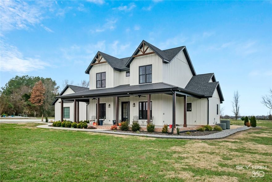 From Country to Bentonville in 12 minutes. This 2509 sq. ft. farmhouse style home, just 2 ½ yrs. old, sits on almost 5 flat usable acres. Enjoy an open floor plan with a gourmet kitchen, farmhouse sink, large walk-in pantry with coffee area, main floor master, office, and tons of storage. The extra room upstairs can be used as a game room, yoga room or storage, your pick. More storage is in the carpeted attic. There is a front wrap around porch with outdoor sound system and fans. Enjoy a covered backyard patio with gas fireplace, fans, sound system, wired for TV and a BBQ area with vented hood system. A sound system is also in the living room and master bedroom. There is an attached oversize 3-car garage and a 40x42 shop with a full bath. Bring your outdoor toys or convert to a granny unit. Be creative! Brand new Anderson Renewal Windows with lifetime transferable warranty. New carpet and R-30 attic insulation. Many extras included in the price.