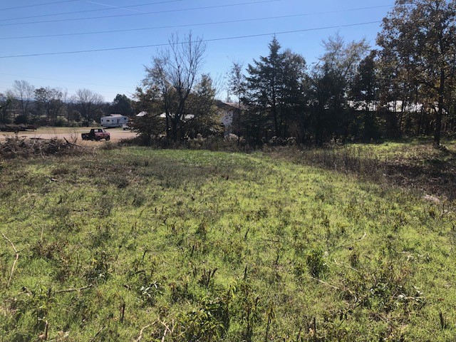 Great location on 5.03 AC for a country house &/or barndominium. Some open land with timber and hardwoods. Located in-between Siloam Springs & Fayetteville. Water is Washington Water. Line may be across the road & a road bore would be required. On asphalt highway with a beautiful view of valley. See 1309527 for add'l acreage.