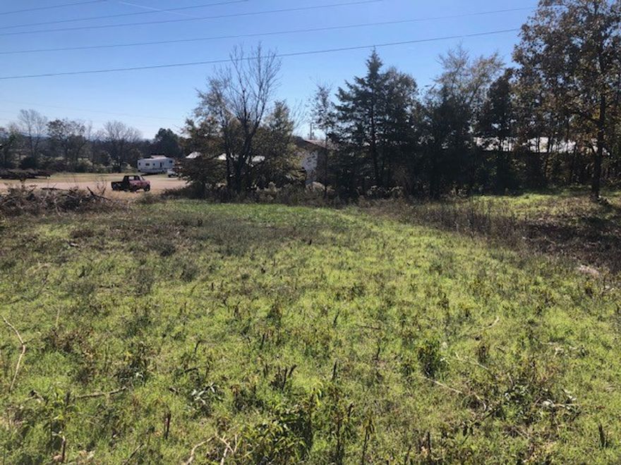 Great location on 5.03 AC for a country house &/or barndominium. Some open land with timber and hardwoods. Located in-between Siloam Springs & Fayetteville. Water is Washington Water. Line may be across the road & a road bore would be required. On asphalt highway with a beautiful view of valley. See 1309527 for add'l acreage.