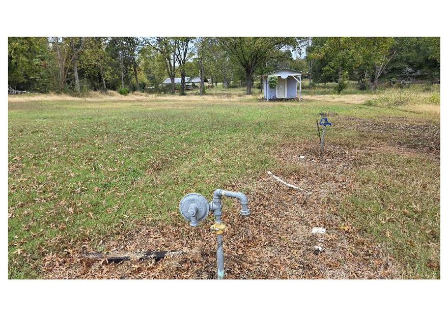 Cleared lot in Lamar with public water and natural gas at the street. Easy access to US-64 and I-40.  It is just over an acre according to the tax record. There is a storage building on the property. AGENTS: see MLS remarks for offer information