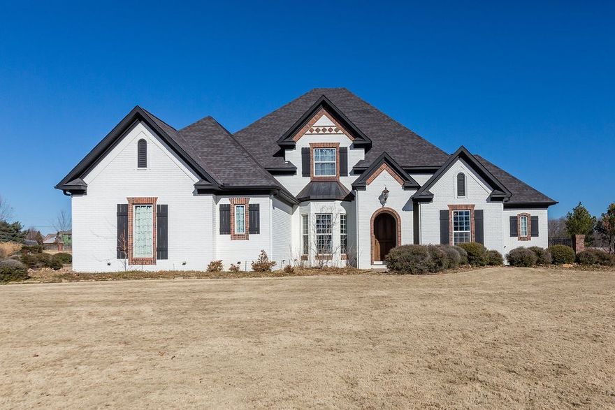 Enjoy crossing the beautiful covered bridge as you reach the 2.98 acre estate located on the quiet and peaceful cul-de-sac in Talamore.  This spacious floor plan offers 2 en-suite bedrooms and private office on the main floor and 3 en-suite bedrooms upstairs; all bedrooms with walk-in closets.  Quality runs throughout with 10 foot ceilings, 8 foot solid core doors, spiral staircase, 2 fireplaces, solid maple cabinets adorn the kitchen complemented with an executive stove and griddle top while true hand-scraped floors flow through the main level.  Custom built outdoor kitchen and living area includes: 2 fireplaces, built-in grill and flat top griddle, fridge, storage and plenty of lounge and bar top seating.  The outdoor entertaining doesn't stop there, relax in the heated, salt water pool that boasts a pool house (with half bath & storage) outdoor shower and expansive pool deck.