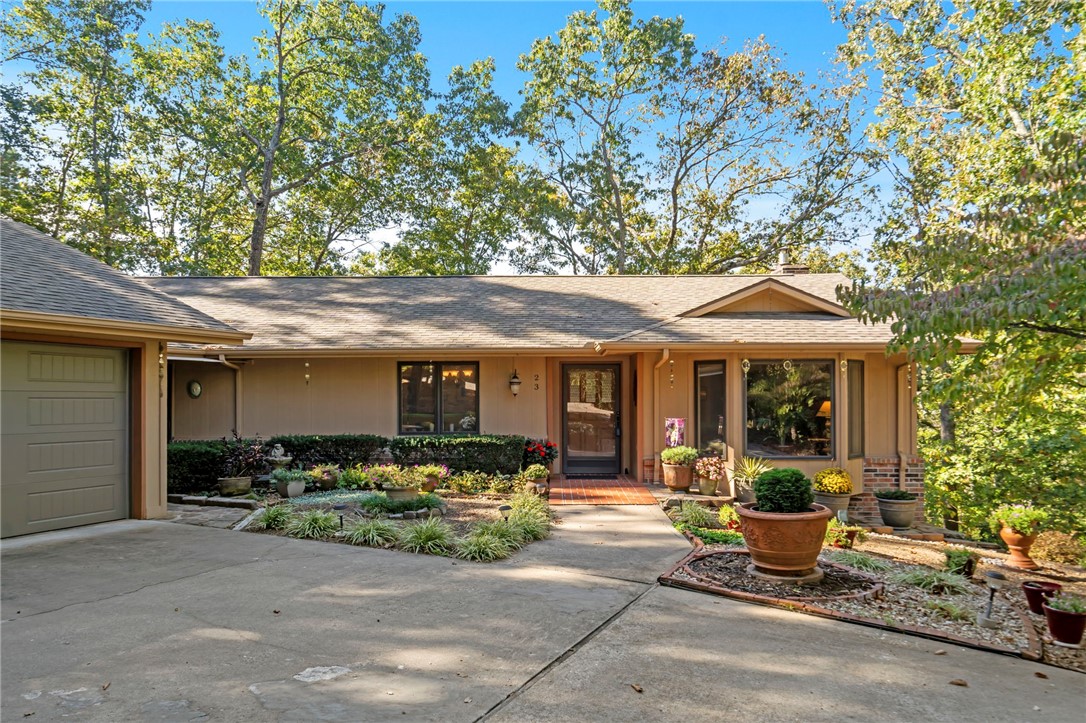 Welcome home, where a blend of comfort, creativity, and connection to nature all meet. This 2764 sq.ft. home is on 1.46 acres, situated directly along the Tunnel Vision Trail. Enjoy the outdoors year-round on the large screened-in porch or one of two spacious decks, and unwind by the breezeway connecting the detached garage, perfect for “sipping and sitting.” Thoughtful design meets personality, with ample wall space for artwork, welcoming gathering areas upstairs and down, and includes a workshop and generous storage. POA members enjoy access to incredible amenities — 7 private lakes for fishing, kayaking, and boating; 7 golf courses; recreation centers and gyms; and a variety of restaurants, clubhouses, and community events. Outdoor enthusiasts will love that this home sits right on the Oz Trail system, connecting you to over 100 miles of world-class mountain biking and hiking trails that wind through the Ozarks. Warm, welcoming, and full of character, a lifestyle surrounded by art, nature, and adventure.