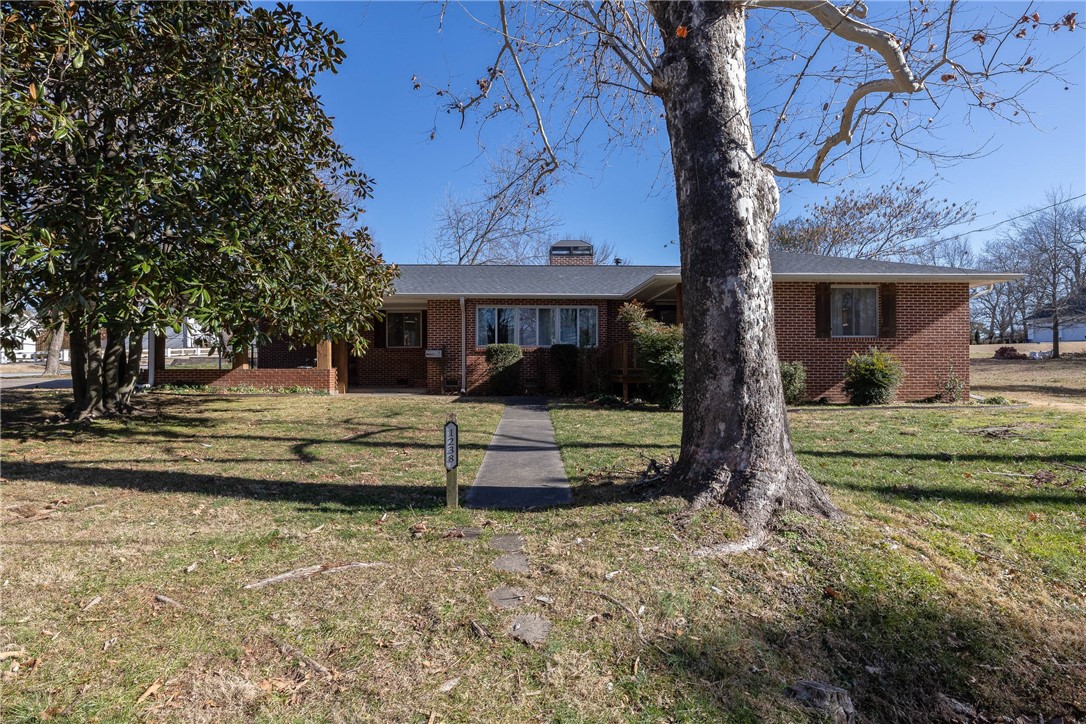 Location, Location, Location!!! Super cute all brick home in prime location 3 blocks from Wilson Park! This one level home offers 1,730 heated sq ft with 3 bedrooms, 2 full bathrooms, oversized living, dining, and eat in kitchen. Laundry and sunroom are not part of the heated and cooled sq ft. Other amenities include hardwood floors, tile surround showers and bathtubs, tons of natural light, gas range, wood burning fireplace, fenced in back yard, perfect deck for entertaining, fully landscaped yard, and a 2 car attached carport. All situated on a level corner lot! The seller has made many improvements including a new roof, new HVAC, electrical, and has a deposit on brand new windows that will be included in the purchase price.