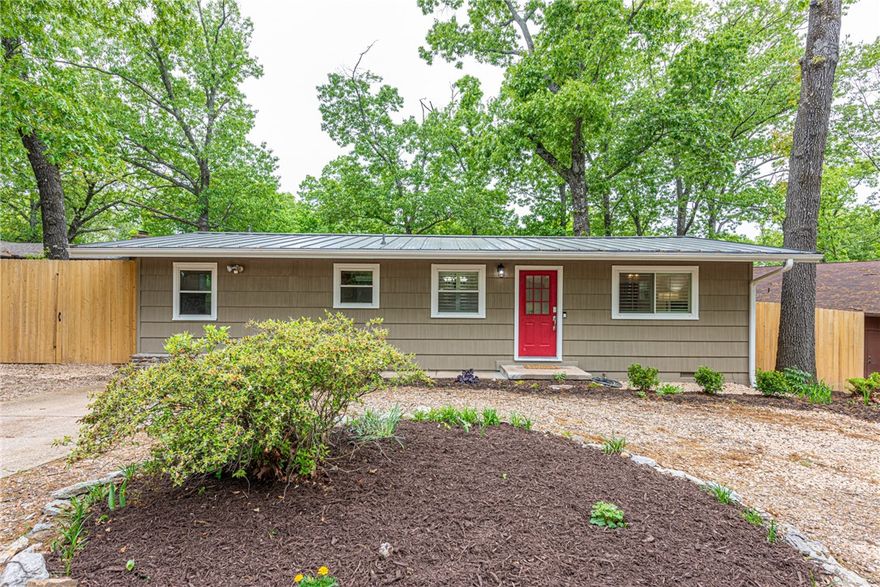 WELCOME HOME! This charming 2-bedrm, 2-bathrm home located in the Lake Avalon area, just minutes from Tanyard Creek, Bella Vista Golf Course, & mtn biking trails like Tunnel Vision. Nearby Hwy 71 and I-49 for quick access to surrounding areas. Front yard feat rock landscaping, and the open-concept interior welcomes you with warm wood flooring throughout the main living space and connects to a dining area with a large sliding glass door that leads to the backyard. U-shaped kitchen is equipped with stainless steel appliances. The spacious primary bedrm includes a beautifully updated private bathrm with tiled shower/tub combo, modern vanity, & contemporary flring. A flexible laundry area provides extra space that could serve as a home office, hobby area, or reading corner! Out back, an oversized deck offers great space for relaxing or gathering, overlooking the fenced backyard. The property also includes a 240 SqFt finished storage building with electricity—ideal for crafts, workspace, or additional storage. Act now!