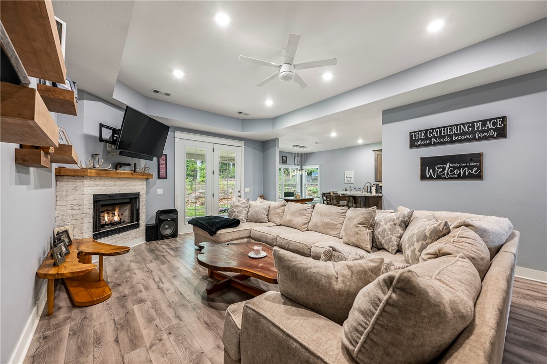 Discover the perfect blend of space, comfort, and convenience with this phenomenal all-brick, single-level home, less than 5 years old. Nestled on nearly 7 acres right in town, this property offers endless possibilities—whether you're looking for privacy, room to expand, or a place to entertain. Step inside to an open concept layout where the kitchen flows seamlessly into a spacious living area, ideal for hosting family and friends. The split floor plan ensures peace and privacy, while the absence of carpet throughout makes cleaning a breeze.