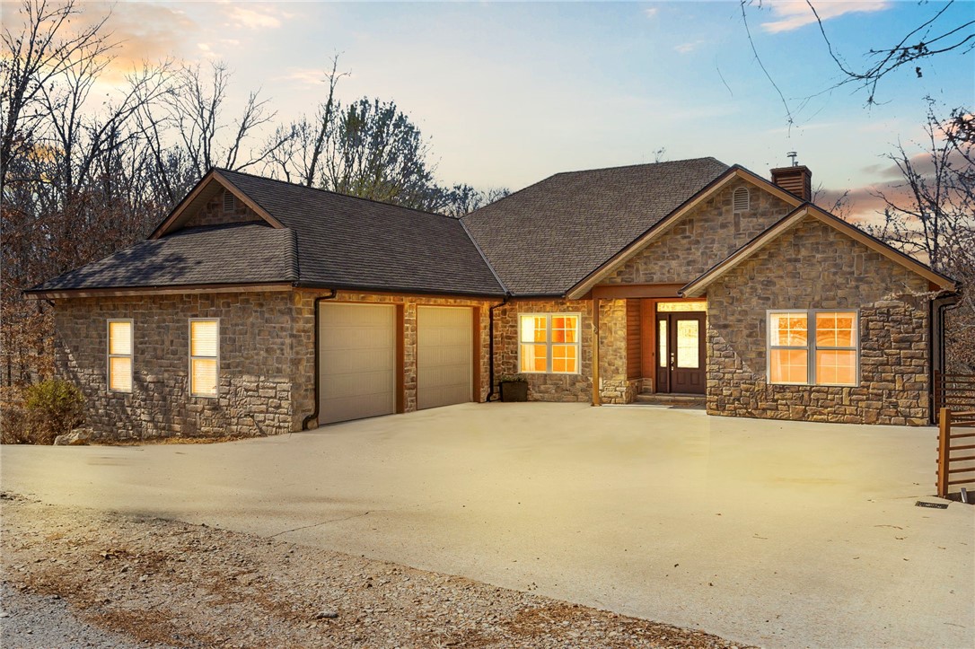 Direct Trail Access to the new Mighty Pine Trail which leads directly to Blowing Springs and the Gear Garden!!! This 4 bed, 3.5 bath home is an entertainers dream with a multiple outdoor porches and decks, and a full bonus room and bar area in the walkout basement. Enjoy multiple deck spaces and a firepit on this oversized lot. As you enter, you are greeted by an open floorplan with solid wood flooring. The kitchen is well appointed with custom in-lay cabinetry finished to the ceiling, stainless appliances, granite countertops, and a slate backsplash. The primary suite is located away from the other two upstairs bedrooms and has access to the custom back deck overlooking the woods. The walkout basement has a large bonus/media room with projector and another full bed and bath (currently used as a gym) with a separate outside entry. Downstairs also has a full back garage space and shop...perfect for projects and bikes!!! Homes this size with direct trail access rarely come on the market...don't miss out!!!