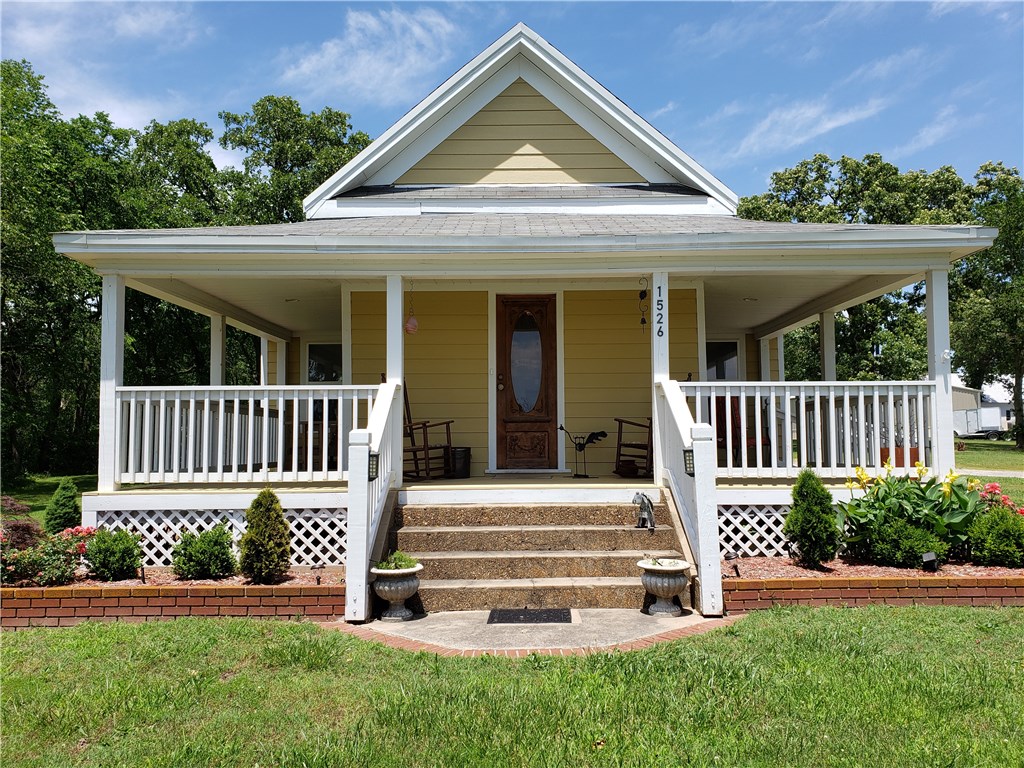 Cute farmhouse, plenty of room and flat yard. Original hardwood floors are beautifully kept. High ceilings & wide molding keep the traditional feel. Home was renovated in 2014 with new window, hardy siding. Addition of a large laundry room and garage give this house even more size and appeal. Front and side flower beds have a drip irrigation system and there is enough flat area to park your RV's and toys. After a long day come and relax on the covered wrap around deck (Home maybe purchases furnished)