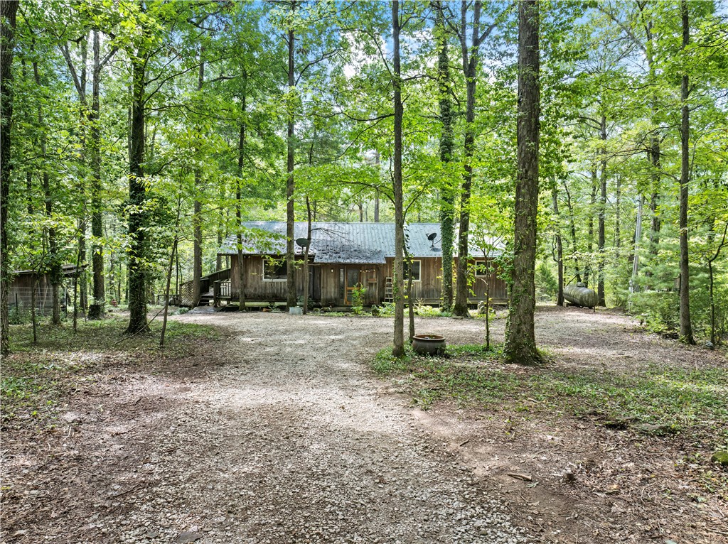 Tucked away at the end of NC 8700, this private retreat is perfect for anyone who craves peace & nature. The custom 2-bed, 2-bath cabin sits on 9± wooded acres with a fully stocked pondāideal for reeling in catfish or simply enjoying the view.
Inside, youāll find spacious bedrooms & a large kitchen featuring beautiful hickory cabinets, an oversized island with propane cooktop, & a walk-in pantry. The cabin is fully insulated, equipped with propane backup heat, & even includes a propane light in the kitchen for power outagesātrue off-grid peace of mind.
Relax on the covered back porch, part of which is screened-in for year-round enjoyment. Outdoors, a metal barn provides extra storage, while the propertyās wooded acreage is rich with wildlife, making it a hunterās paradise.
Whether youāre looking for a weekend escape or a full-time lifestyle surrounded by seclusion, fishing, & abundant wildlife, this cabin delivers it all.