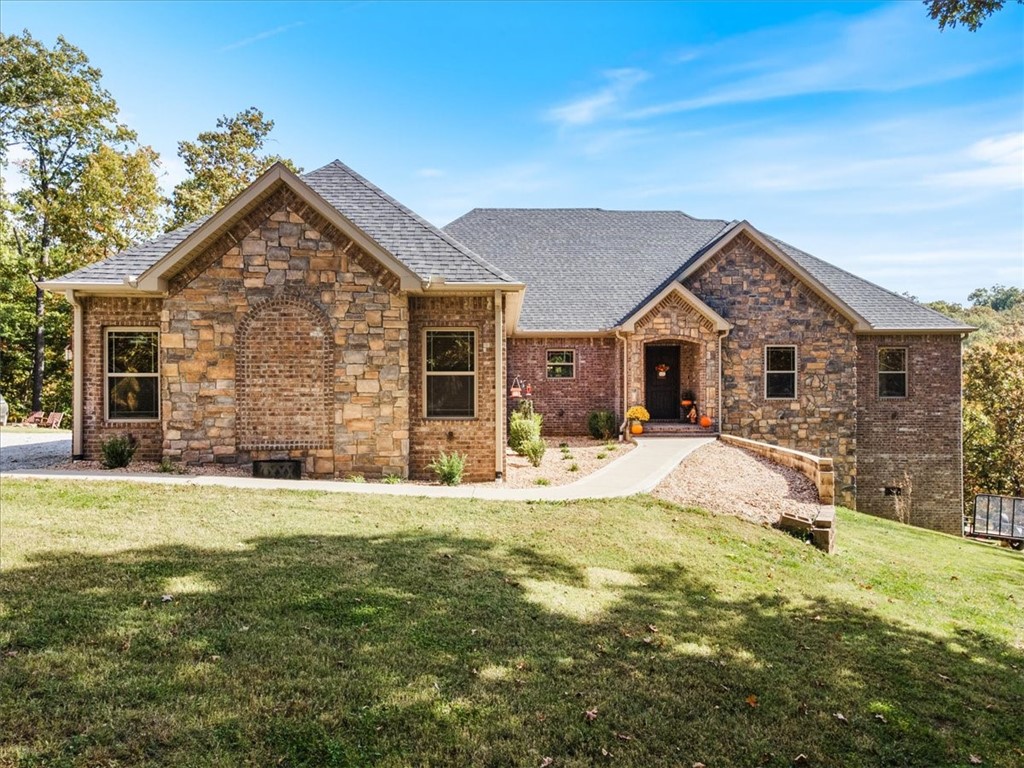 Introducing a magnificent custom property in a wonderful area on 2.7 acres. Bentonville Schools! 3,456 sq. ft.-4 bed and 3.5 bath, this property caters to both families and those seeking extra space. Large gourmet kitchen, easy to host gatherings or enjoy family meals. A Beautiful wood-burning fireplace, complete with fans and ductwork for efficiency. Thoughtfully designed features such as tall ceilings, crown molding and custom blinds, built-in dog kennel for your furry friends. Laying hens for fresh eggs! Safe Room for peace of mind. Gutter guards around the entire house. Large deck space for outdoor entertaining or enjoying nature. Auto driveway lights add convenience and safety. One of alluring aspects of this home is its proximity to recreational bike trails, perfect for outdoor enthusiasts. This property stands out as a unique two-story home with big workshop and storage underneath.Added space completes this already impressive package. Be in for Holidays and start making your own unforgettable memories.PEACE
