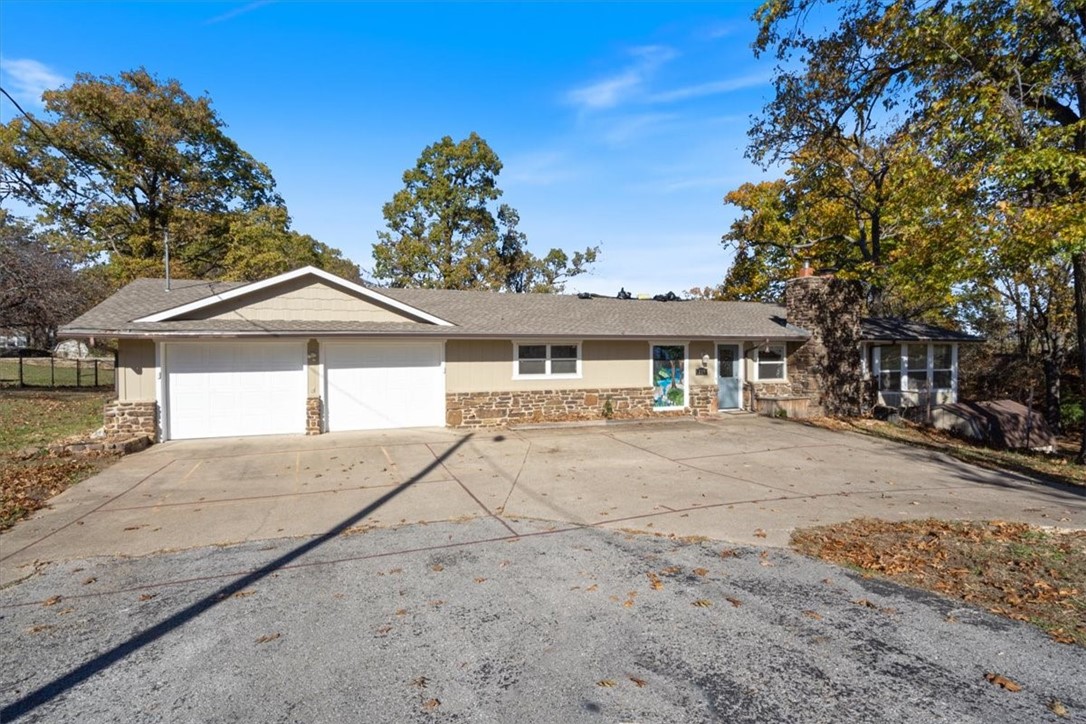 2.91 acre property can have horses, chickens, etc. but close to all the amenities, feels like country living. 3,000 two level sq. ft. home situated in Little Flock. Upgrades, Updates, 4 bedroom, 2 bath, Large Deck, Patio, wood buring insert for the cold nights, saves on utility cost. This property boasts Asian and Bartlett pear trees, Cherry and Plum Trees, as well as 3 sugar Maple trees, Oak, Black Walnut and Sycamore trees. In addition there is a Dawn Redwood & Weeping Willow tree.
For outdoor enthusiasts there is a two level tree house with a climbing wall offering a space for playful adventures in nature! The property is fully fenced and secure. Also, Freshly Painted- New HVAC in 2022, includes a 8x12 storage shed- upgraded insulation, new french doors, and a dog run for your furry friends. The wrap around deck and large living areas make this a very desirable home. Don't miss your opportunity to own this tranquil haven that combines the beauty of nature with the comfort of modern living.