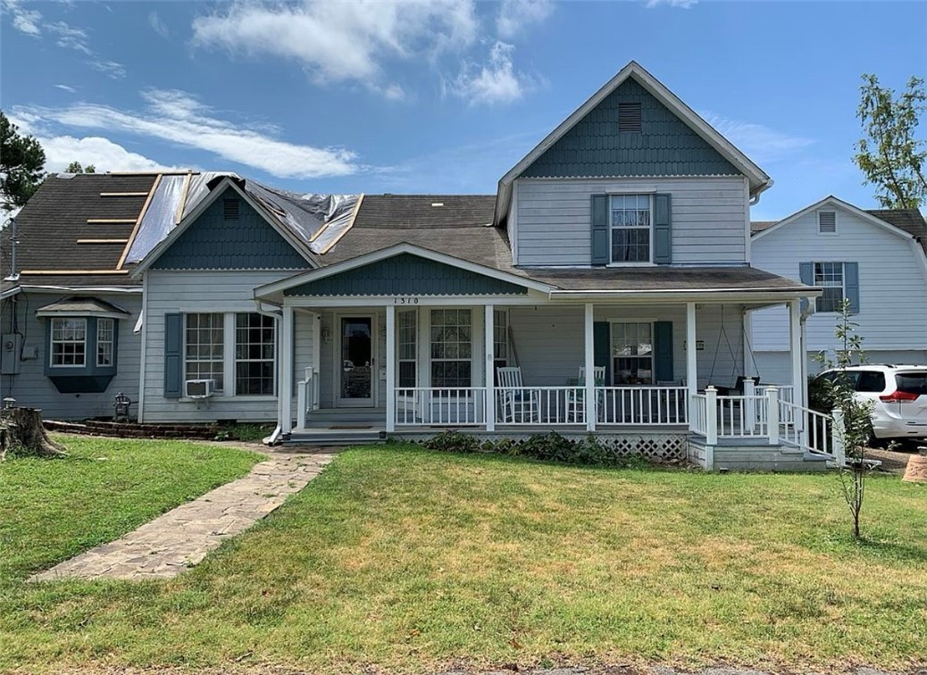 This one-of-a-kind property offers over 5,265 sq ft of character-filled living space, plus a 1,320 sq ft heated and cooled garage and workshop. Inside, you'll find 5+ bedrooms, 3.5 baths, multiple living areas, a sunroom, playroom, and even a private guest apartment. Step outside to your own backyard retreat with an in-ground pool and fountain, cabana, pool house, and charming 12x16 barn. The flat driveway provides plenty of parking, and you’re just a short walk to parks, schools, the library, restaurants, and trails. Some tornado damage (roof, drywall, 1 AC unit) has occurred, but much of the home remains fully functional, including the kitchen, plumbing, electrical, and second AC. A new roof is already on its way! Plus, an additional lot is included—perfect for future expansion or investment. So much potential waiting for its next chapter!