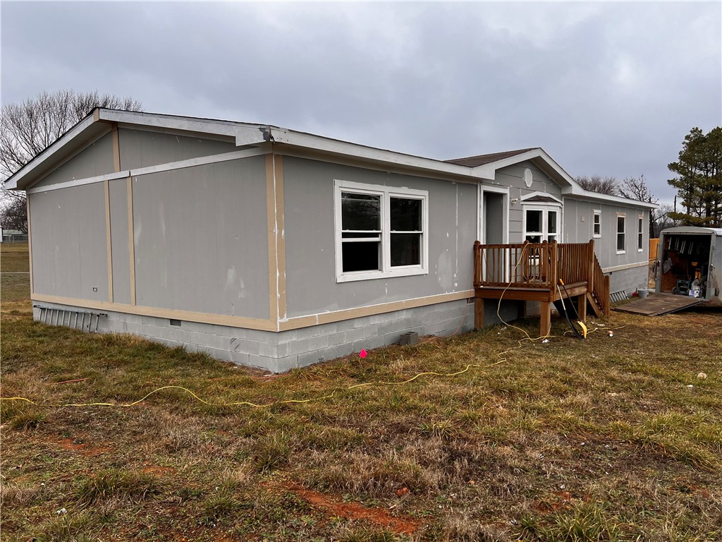 Mobile home sitting on a permanent foundation. 1 Acre lot. Completely renovated. New Roof, Septic, Floors and Many more.