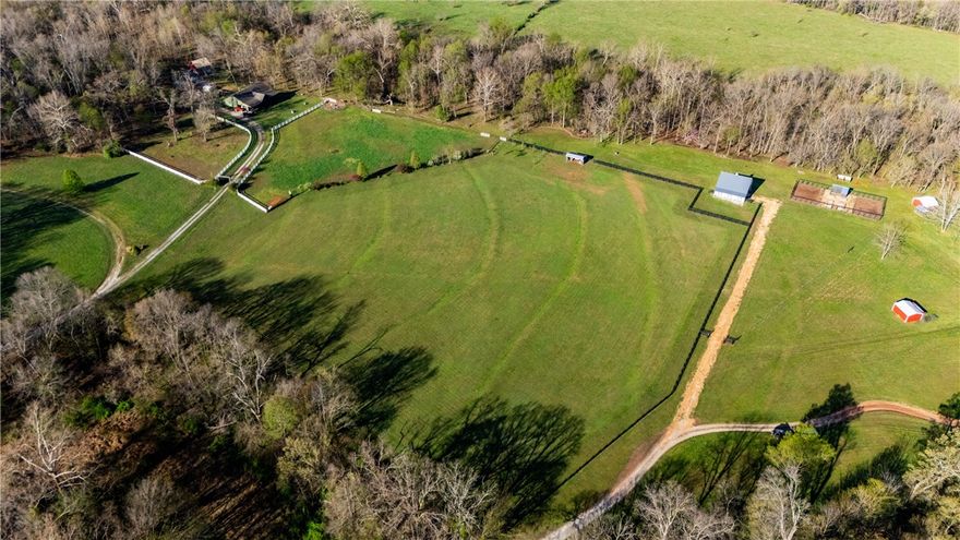 This peaceful 8.82-acre rural property features a cleared pasture bordered by a four rail 
wood fence on three sides. Close to Spavinaw Creek. The Morton-built equestrian barn with electricity, loafing shed, and raised bed garden with greenhouse provide great amenities for animal lovers and gardeners. Perfect for those seeking a serene country retreat with plenty of space and privacy.