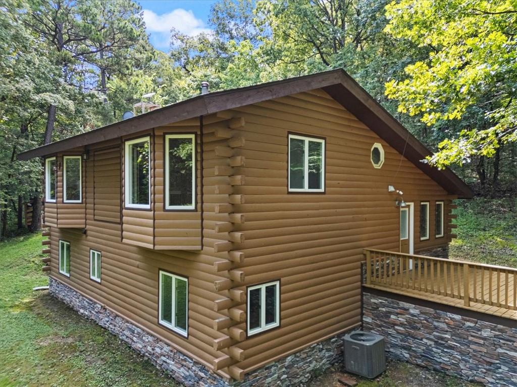 Nestled on 6.31 acres of wooded land with nature right outside your front door, this updated log-sided home blends rustic charm with modern comfort. Recent improvements include a new roof and skylights (2023), new furnace and water heater (2024), whole-house water filtration, refinished and new hardwoods, remodeled primary bath, new deck off the primary bedroom, and new refrigerator/washer/dryer included. Home also features additional den or office space. Outdoor enthusiasts will love being minutes from Illinois River and Gypsy Camp canoeing, WOKA Whitewater Park, Fisher Ford Kayak Park, and 6 miles of bike trails to WOKA. Ideal as a full-time home, weekend retreat, or short-term rentalādowntown Siloam Springs shops and restaurants are only a quick 10-minute drive.