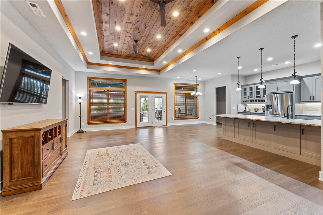 Absolute best home in neighborhood with a brand new price! The curb appeal excites you, but the WOW effect engulfs you when you open the door! Wood floors are abundant throughout home with office directly to your right for work at home days. The open living room has a wall of windows beaming natural light throughout, gorgeous fireplace and wood ceiling opening to a marvelous kitchen with exotic granite counters with large peninsula. Kitchen features plenty of modern cabinets, GE Profile 5 burner gas range with convection oven and high end appliances. Large primary bedroom with a double custom trey ceiling with an ensuite featuring huge WIC, freestanding tub, full walk around custom tile shower and dual vanities. 3 more bedrooms on opposite side all with WIC's with two sharing a Jack and Jill bathroom is perfect for kids. Fenced backyard with a full custom outdoor kitchen and firepit under covered patio, perfect for entertaining. Whole house water filtration system & 6 camera security system.