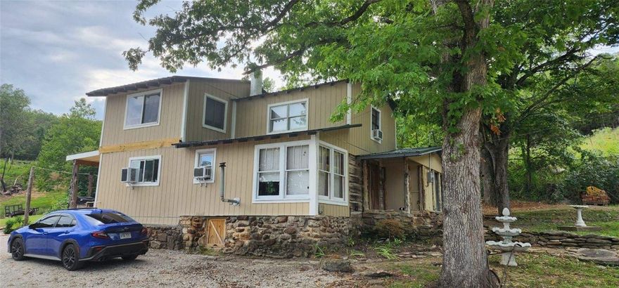 CABIN and CAVES? You bet- this exceptional Ozarks property delivers adventure and comfort on one scenic parcel. Two natural caves provide unique exploration opportunities while the location places you minutes from the Buffalo River for canoeing, fishing, and hiking. The home is updated with new floor coverings, refreshed paint, new kitchen countertops, a new water heater, and a new deck for outdoor living. Outbuildings include a brand-new 24x40 shop, a new shed, and a large older barn with a loft offering versatile storage or hobby space. Enjoy the new above-ground 12x24 pool and a newer six-person hot tub for relaxation after a day outdoors. Recent well upgrades include a new pump and all-new wiring throughout the property. Ideal for hunters with all outdoor amenities. Interested in air bnb- this one could serve both as private home and bnb. Call for your private showing today!