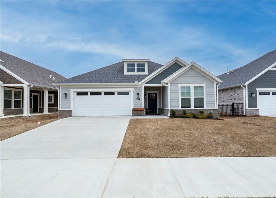 Enjoy relaxed, low-maintenance living in the sought-after The Courtyards at Owl Creek, a 55+ active adult community in West Fayetteville. This nearly new home features a bright open-concept design with 2 bedrooms plus a versatile flex room—perfect for a home office, study, or den. The inviting living area is centered around a gas log fireplace with custom built-in shelving, creating a warm and welcoming space to gather.

Step outside to your private courtyard retreat with an upgraded covered patio overlooking Owl Creek and peaceful greenspace, accessible from both the living room and the spacious primary suite. The primary bath offers double vanities and a walk-in shower for everyday comfort.

Enjoy true lock-and-leave convenience with HOA-covered lawn care, sprinkler maintenance, and snow removal. Future neighborhood amenities include a clubhouse and pickleball courts. Ideally located near trails, parks, shopping, dining, and quick access to I-49.