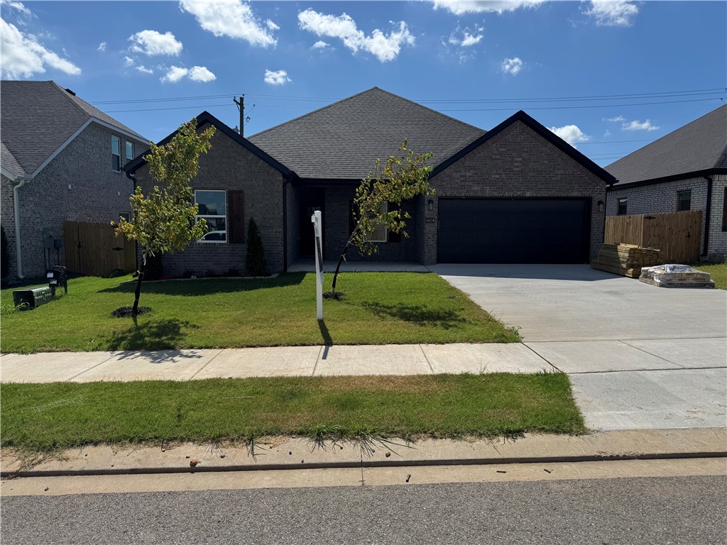 Welcome to a beautiful home in a vibrant new Bentonville subdivision! This beautifully designed new construction home boasts a spacious split floor plan with custom built cabinets & a large kitchen island, perfect for entertaining. The inviting living room features a cozy fireplace, while the kitchen is equipped with a stylish wine rack for all your favorites. Enjoy luxurious touches throughout, including 2 inch faux wood blinds, & rain head showers in the bathrooms. The master suite offers a custom tile shower & tub, complemented by generous walk-in closets. With an eat-in kitchen, covered back patio, & a fenced yard, this home is ideal for family gatherings & outdoor living. Plus, you’ll appreciate the convenient location just 10 minutes from XNA Airport.