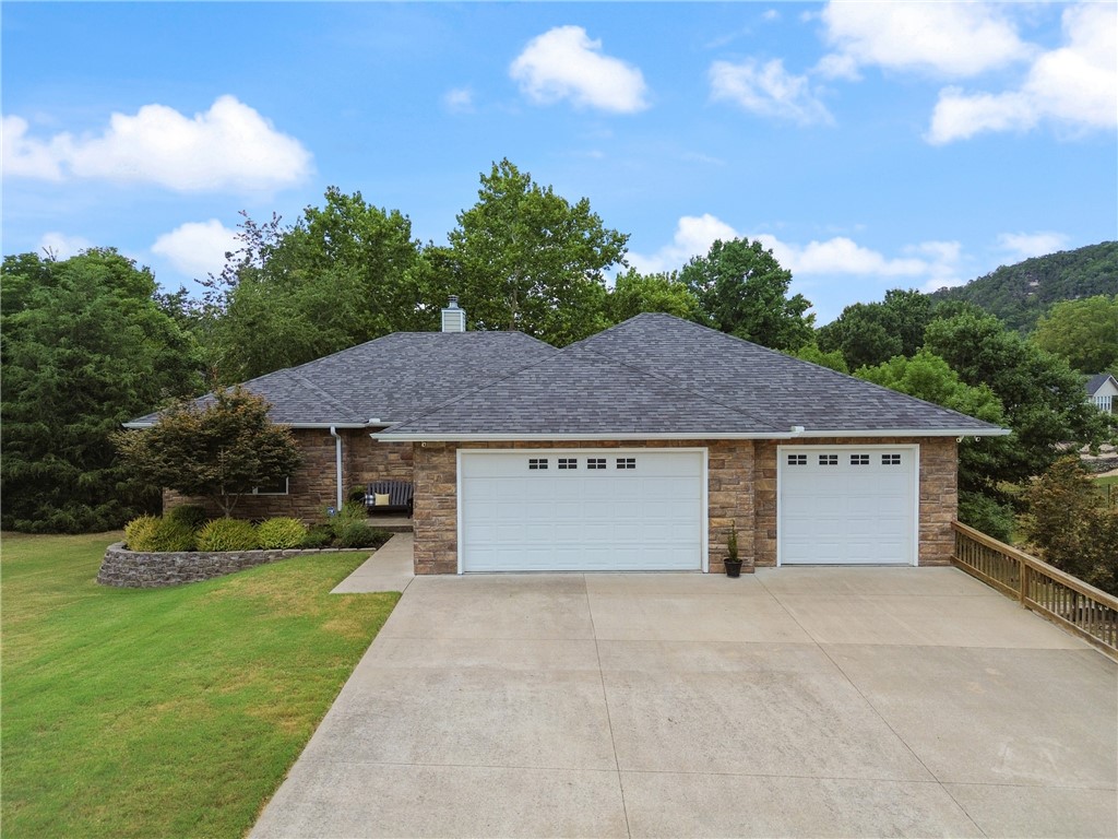 Beautifully maintained 2-story lake home featuring 3 bedrooms and 3.5 baths, designed for comfort and style. The main level boasts custom cabinets, wood laminate flooring, and bright, open living spaces. The lower level offers extra living space along with bedrooms and a full bath; ideal for guests or extended family. A 1,000 sq. ft. garage includes an extended 33ā bay and a dedicated workshop, perfect for projects and storage. Outdoors, enjoy a fenced yard with meticulous landscaping, creating a private oasis. Located just steps from the lake, this home combines function, beauty, and the perfect setting for lake life. Beautiful hardieboard and stone exterior with tons of windows allowing a light and airy feel. New kitchen appliances 2022, new front door 2022, new roof 2022, new garage door opener 2025, new hvac 2024. Gorgeous pallet swing to convey at no cost as well as washer and dryer. This home is ready for you!
