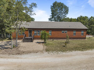 Welcome Home! This 4 bedroom, 2.5 Bath split floor plan home, by Clayton Homes, is well kept and move in ready! Come sip your morning coffee on the back deck or gather around the huge kitchen Island with family and friends! 21.45 acres, a wet weather creek & Amazing view! Come take a look at this home. 7 garden beds, tent shed (10x12), and Water tanks will be included in the sale. The water tank catchment system is currently used for watering the garden and fenced in backyard that also features a dog run! This property is perfect for hunting and hiking. Conveniently located about halfway between Branson Missouri and Harrison Arkansas. Jetted tub in the master bathroom and a built-in vanity. The fireplace is propane but can be convert to Wood burning by removing the insert