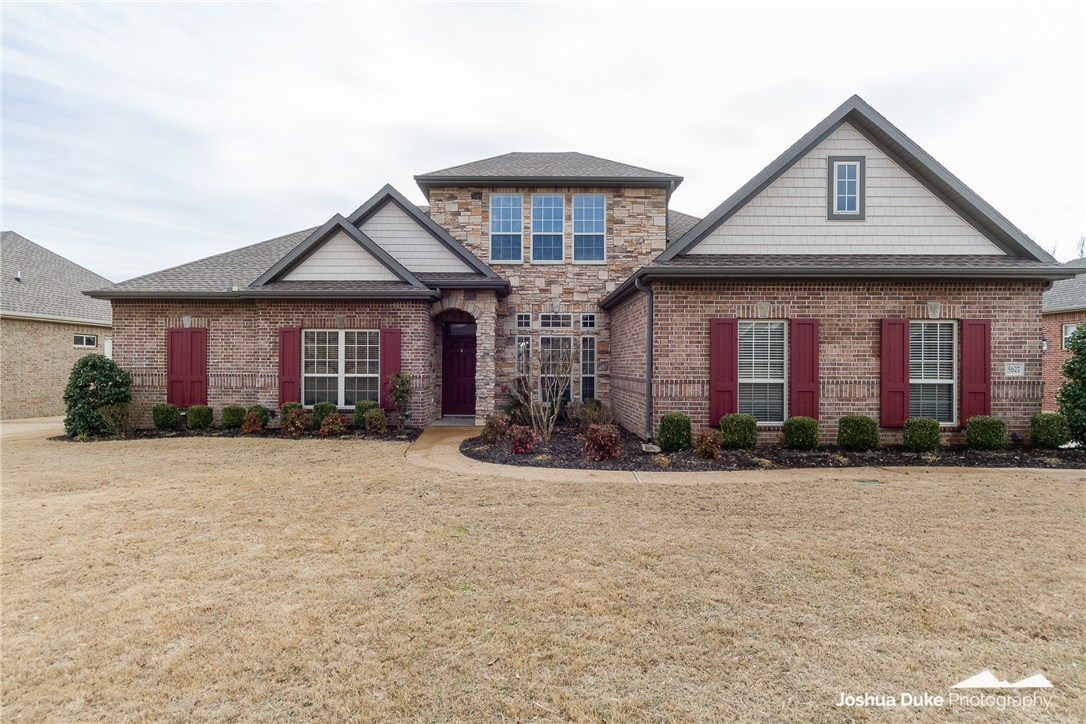 Beautiful Buffington Construction home in like new condition. Full brick and stone exterior, great landscaping, front yard and flower bed irrigation, 10 ft ceilings throughout, hardwood floors in the foyer, family room and dining room with new carpet in the master, 18" tile in all wet areas, granite in the kitchen with stainless steel appliances and charming light fixtures. Open floor plan on the main level and bonus room plus half bath on second level. Spacious deck and privacy fenced backyard. 3 car side loading garage.