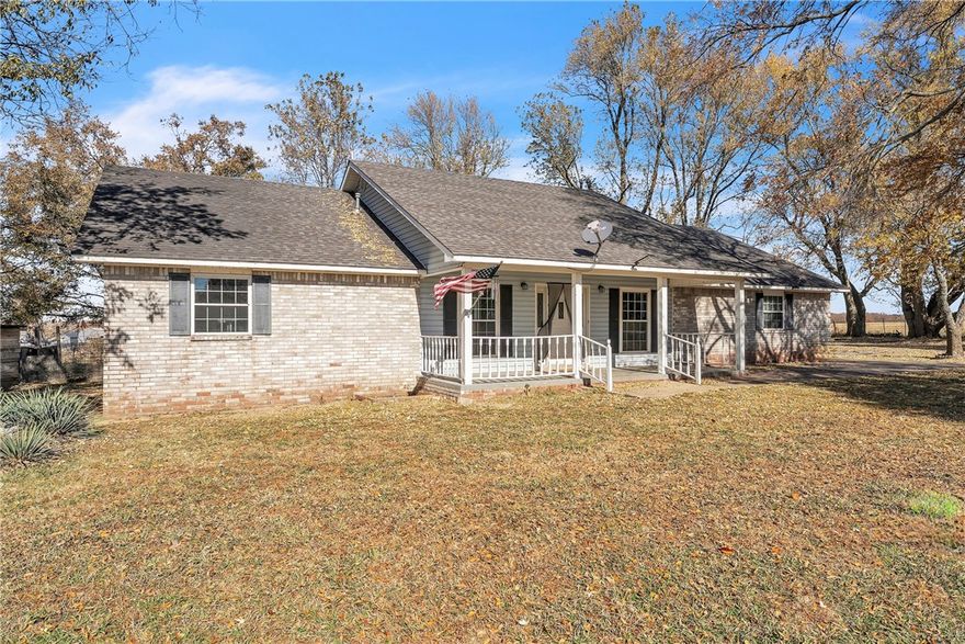 Welcome to a beautiful 4-bed, 3-bath country home on 2.35± acres. The expansive covered front porch is the star of the show, the perfect place to relax in rocking chairs, enjoy morning coffee, watch  breathtaking sunsets, or visit with friends while taking in the quiet rural views. The spacious living room features a striking wood-burning fireplace. The open eat-in kitchen boasts abundant cabinetry, generous counter space, bar-height peninsula, separate cooktop, and wall oven. A separate formal dining room off the entry is ideal for gatherings. There are several fruit-bearing trees including a cherry and apple tree!