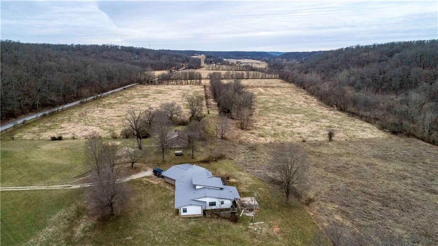 Remarkable location close to Bentonville, Rogers and Little Flock, short distance to Pea Ridge.Own your own Mountain! Live Creek! Development Potential!!! Tremendous location a paved road with public water available! Between Bentonville and Pea Ridge. Gorgeous 112 ACRES with Sugar Creek running through it. Creek runs along the bluffs! Bluffs are absolutely beautiful. Plus Fantastic gorgeous views! Close to Interstate 49 from Hwy 72 in Bentonville. Property is located in both the Bentonville and Rogers School Districts. In the City of Little Flock jurisdiction. Beautiful acreage includes 2 homes. One is newer with lots of nice features! 2nd is older home that a remodel had been started on.