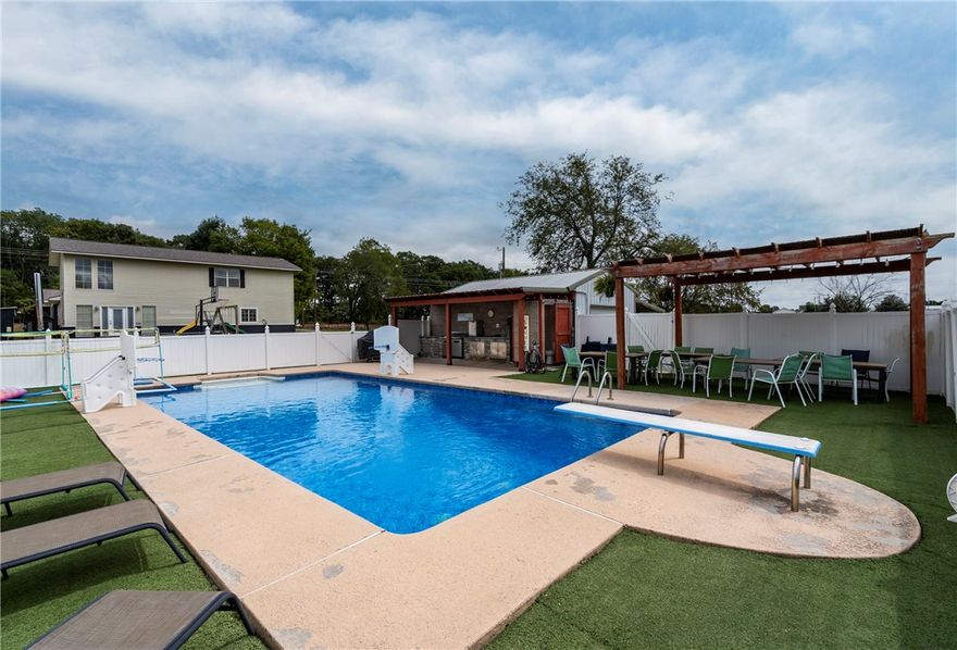 Wood stove recently removed, and house is now heated with propane central heat. Step onto the inviting front porch and into a spacious living room perfect for gatherings. The backyard features an 18’x36’ saltwater pool, outdoor kitchen, and gazebo, all privately enclosed by a vinyl fence. Inside, the enormous Master Suite offers serene backyard views, a luxurious bath with soaker tub and walk-in shower. Two bedrooms include a built-in library and Murphy Bed for guests. The eat-in kitchen offers a custom epoxy countertop island, and kids will love the backyard playground. Located just a quarter mile from I-49 for easy access to cycling trails, Bentonville, and Gravette schools, this home offers both convenience and tranquility. With outbuildings and recent updates including a new roof (2019) and pool liner (2022), and newly paved road, it’s an ideal retreat, short-term rental, or commercial opportunity.