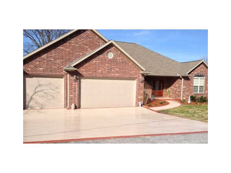 Epoxy floor in garage custom stamped conc driveway granite counters ss appliances vaulted backlit tray ceilings arched entry elegant pilars crafted strand bamboo floor with custom inlays too many extras to list!
