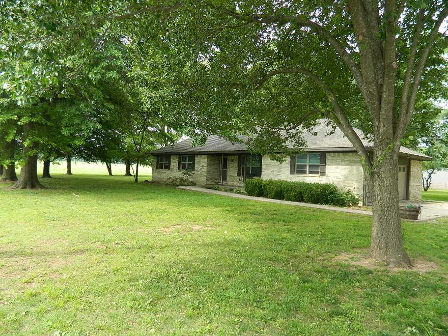 3BR/1BA - 1,160 SF - Nestled in the peaceful countryside yet conveniently located near town, this charming home offers the perfect blend of privacy and accessibility. The inviting open-concept layout features a spacious kitchen, dining and living area centered around a cozy wood stove - creating a warm and welcoming space for everyday living or entertaining. Large windows allow natural light to fill the home, adding to its bright and comfortable feel. Enjoy quiet mornings on the covered front porch and relax in the evenings on the covered back porch overlooking the surrounding property. An additional open outdoor dining area provides the perfect setting for gatherings, grilling, or simply enjoying the fresh country air. With its inviting layout, outdoor living spaces, and serene setting, this property is ready to welcome its new owner's home.