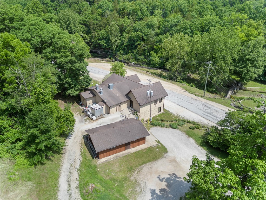 You have options with this one!!! 20.69 ac m/l of both cleared land and hardwood, paved road access and a cave where Bear Creek begins its year round journey all the way to Bull Shoals Lake. It has some infrastructure already in place to make adjusting water levels to the onsite trout farm that much easier. The building currently being used as a restaurant has almost 5200 sq ft (top&bottom) and can be split into two separate spaces fairly easily. Being only 30 minutes to Branson, MO, a little over an hour to Northwest Arkansas and about 30 minutes to the Buffalo National River, this property has a lot of options.