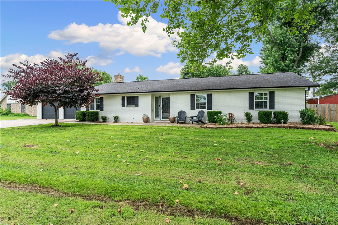 Experience grandeur at 1711 Mayflower Rd, Bentonville, AR 72713! This 6-bed, 4.5-bath estate on 1 acre offers 2 living rooms, 2 kitchens with a marble island in the main, a great room, 2 laundry rooms, and space to thrive. Ideal for multifamily, Airbnb, or retreats, it boasts new flooring, a refreshed master bath, and custom cabinetry. Car lovers rejoice with two 2-car garages and a 30x40 ft detached garage holding 4 cars (8 with lift, current lift excluded), featuring insulation, heated/cooled mini-splits, and secure storage. Updates include HVAC (2024/2023), 50-gal gas water heater (2024), 2016 roof, and 2020 carpet. A storm shelter fits 6-8. Sellers offer $5,000 toward repaint/closing costs. Near Thadden Field Airport, Bentonville Brewing, and close to downtown’s various museums, Razorback Greenway, and major Fortune 500 companies; this home blends luxury and convenience. Perfect for growing families or investors, seize this rare gem in booming Northwest Arkansas—book your private showing now!