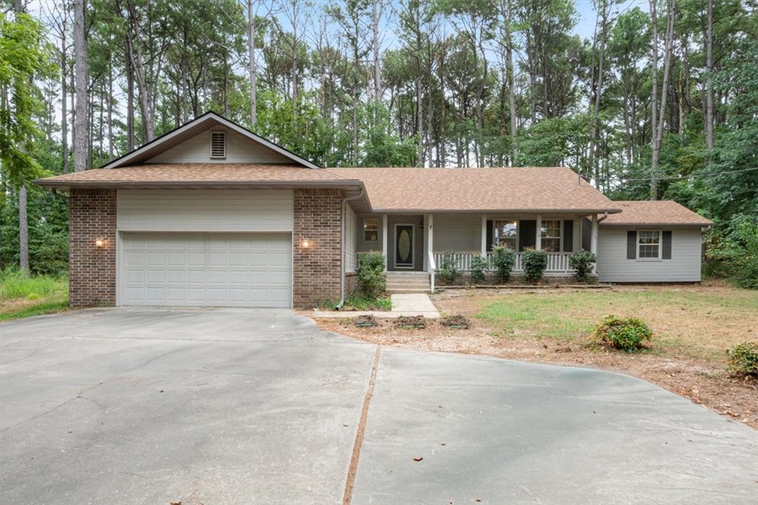The three bears lived in a sweet cottage like this one at 7 Skye Drive. Enveloped by the tallest pine trees ever, this home would definitely be a respite for Goldilocks and other humans too. It sits near the back of the lot with a nice big driveway and yard and it is flat. Goldilocks was especially taken with the three bedrooms and two bathrooms and the cathedral ceilings. Mrs Bear enjoyed doling out porridge in the kitchen that opened up to the diningroom. Bears can be prolific with mating so they also enjoyed the separate room in the back with electricity, to put all the extra family that visits. The bears also like the proximity to Loch Lomond for catch and release bass fishing but they often don't release. While bears did not live here, the cottage could use a little aesthetic updates like new carpet and countertops, but for the unpicky bears it could be move in ready. This sweet Cottage in the Pines won't last long, especially with people like Goldilocks who think its just Right!