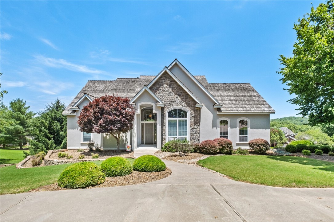 Experience Lakeside Living at its Finest with this Custom-built Home on Beaver Lake, featuring a Boat Slip in Community dock. Located in Desirable Prairie Creek area, just 5 minutes from downtown Rogers, this Home boasts Fresh Updates & Modern Amenities. Enjoy Professionally Painted Woodwork, Ceilings, & Walls, New LVP Flooring, Solid Oak Stair Treads, & Plush Bedroom Carpeting. Recent Updates include New HVAC & Roof.
The Spacious Primary Ensuite offers Seasonal Lake Views, Cozy double-sided Fireplace, Trayed Ceilings, & Large Walk-in Closet w/ Built-ins. The Open Floorplan features a Grand Family Room w/ Cathedral Ceilings & Panoramic Seasonal Views thru Ample Lakeside Windows. The Kitchen is a Chef's Dream w/ Custom Site-built Cabinetry, Gas Stove, & Wall Oven. Add. Highlights incl. Two Staircases, a Heated/Cooled Room off 2 Car Garage perfect for Gym or Office, & Lower Level w/ Extra Storage &Workshop equipped w/ 220v plug & Double Exterior Doors. Home Warranty conveys. Welcome Home!