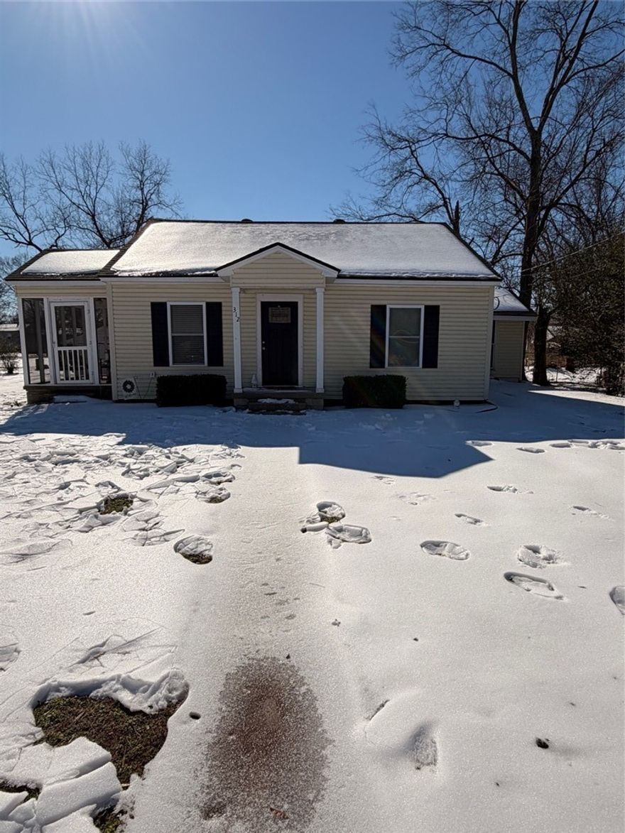 Welcome to this charming 1940 home at 312 E. H St. in the heart of Russellville. This single-level home offers 3 bedrooms and 2 full bathrooms with a thoughtful blend of classic character and modern updates. Inside, you’ll find newly painted interiors, luxury vinyl plank flooring, and a versatile den or office that could also serve as a second living area. The kitchen features granite countertops and connects easily to the main living spaces. A functional mud room adds everyday convenience. Recent updates include a new hot water tank and a new exterior HVAC unit. Outside, enjoy two covered porches—one screened in—perfect for relaxing or entertaining. The property also includes a detached one-car garage and 30-year galvanized shingles. Located near Arkansas Tech University and within walking distance to downtown Russellville’s dining and entertainment, this home offers comfort, charm, and an unbeatable location. Fiber optic internet is available at the street, making it ideal for work-from-home needs.