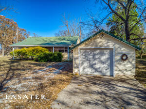Your search is over. This place is perfect. Just enough room for the 1st time home buyer, newlyweds, or empty nesters. Close to everything you need in town, and still feels secluded. Relax on the shaded front porch, or enjoy the spacious yard, with large fire pit, single car garage, storage shed & Old time cellar. Nice landscaping and large established shade trees.The interior of the home has two bedrooms, one full bath, an office, bonus room, living room, and kitchen/dining combination with laundry. The back room can also be used as a sunroom. Two gas wall heaters, 2 window unit air conditioners, and a newer septic. Home is well insulated and has metal roof. This home is neat as a pin and ready to move in.