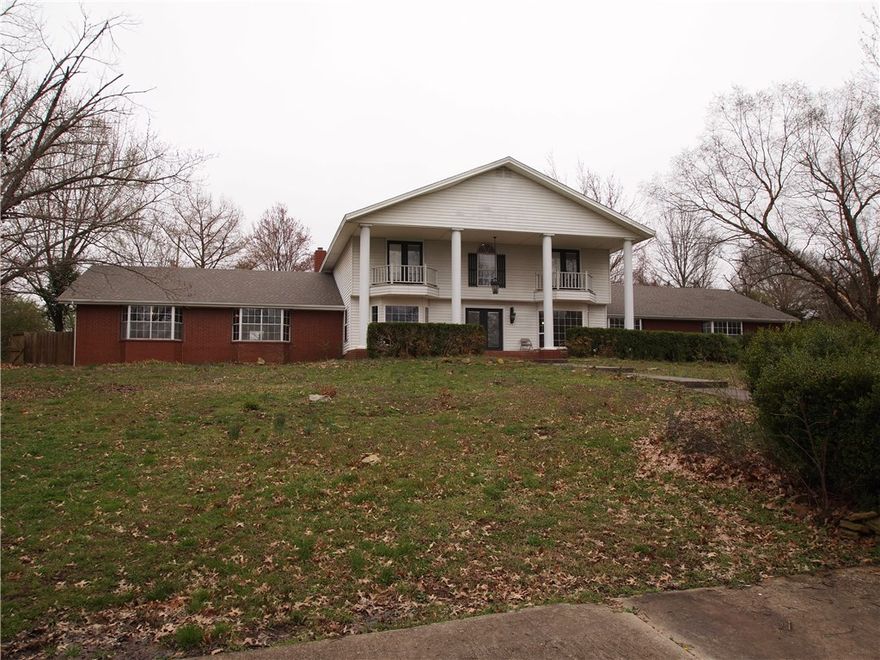 Estate home on 4.48 park like acres less than 1 mile away from Bentonville square.  Many possibilities with this property.  Could be a development, event center, or keep it as an estate home.  5,972 SF home with an additional 1,500 SF indoor pool.  Fresh interior paint, brand new roof, brand new HVAC systems, new carpet and resurfaced hardwood flooring.  Purchase this home and make it your own with updating kitchen and baths to your specifications.  Rare opportunity to own a large estate in the heart of Bentonville.  Property borders the original Wal-Mart Supercenter to the south.  Lots of seclusion, convenient to everything Bentonville has to offer.  Most recently was a bed and breakfast.