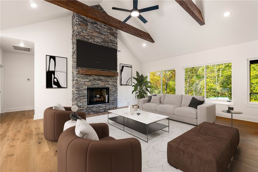 Beautiful new construction by Elite Thomas Homes — move-in ready! Backs to the Flo Ride bike trail and offers the perfect blend of recreation and convenience—less than a mile from the Lake Ann boat ramp. This thoughtfully designed home features an open-concept living area with vaulted ceilings accented by wood beams and a stacked-stone fireplace. The kitchen and dining spaces provide plenty of room for gathering and entertaining. The laundry room conveniently connects to the primary closet for added functionality. The main level includes two bedrooms plus an office, with wood flooring throughout. The home offers a stylish tiled guest bath and a spacious primary bath with a large tiled shower featuring dual shower heads, a double vanity, and a linen closet. The partial walkout basement includes a media/game room with a wet bar and half bath, with premium carpet on the stairs and lower level. Enjoy outdoor living on two covered decks—one off the kitchen and one from the basement—perfect for relaxing or entertaining.