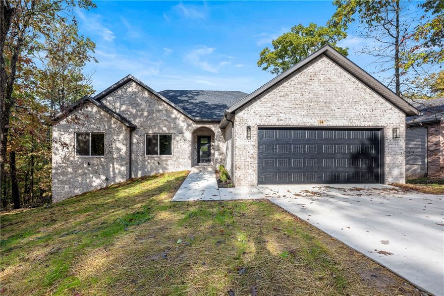 Beautiful new construction by Elite Thomas Homes — move-in ready! Backs to the Flo Ride bike trail and offers the perfect blend of recreation and convenience—less than a mile from the Lake Ann boat ramp. This thoughtfully designed home features an open-concept living area with vaulted ceilings accented by wood beams and a stacked-stone fireplace. The kitchen and dining spaces provide plenty of room for gathering and entertaining. The laundry room conveniently connects to the primary closet for added functionality. The main level includes two bedrooms plus an office, with wood flooring throughout. The home offers a stylish tiled guest bath and a spacious primary bath with a large tiled shower featuring dual shower heads, a double vanity, and a linen closet. The partial walkout basement includes a media/game room with a wet bar and half bath, with premium carpet on the stairs and lower level. Enjoy outdoor living on two covered decks—one off the kitchen and one from the basement—perfect for relaxing or entertaining.