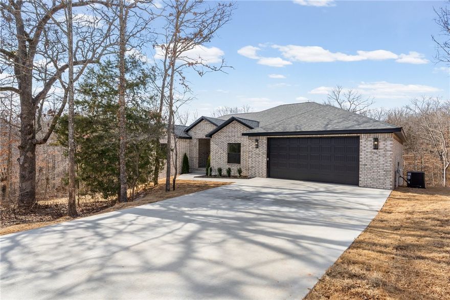 This one level home offers 3 bedrooms, 2.5 bathrooms, an office or flex space, and a split floor plan designed for both comfort and privacy. The open layout features engineered hardwood flooring throughout with tile in the bathrooms and no carpet anywhere!

Large windows bring in natural light and wooded views, while sliding doors lead to a covered back deck. The kitchen includes quartz countertops, a spacious island, full height cabinetry, and black hardware for a clean, modern feel.

Located just minutes from Lake Loch Lomond, Highlands Golf Course, and Branchwood Recreation Center, with convenient access to the Bella Vista Bypass for easy travel throughout Northwest Arkansas.

A 3,000 dollar lender credit is available through preferred lender Shayna Boyster with AMC Mortgage.