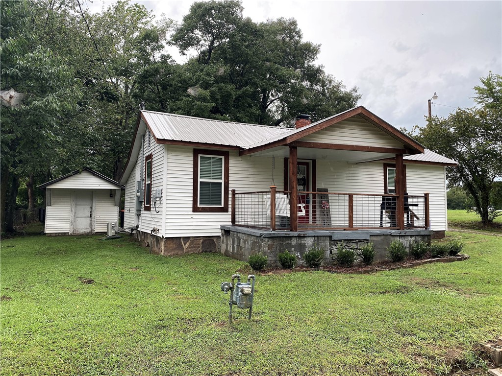 Recently remodeled home with New electric, plumbing, sheetrock, windows, insulation, appliances, floor coverings, light fixtures, heat/air and cabinets. Has vinyl siding with a metal roof. Has a great front porch with a huge back yard and storage building.