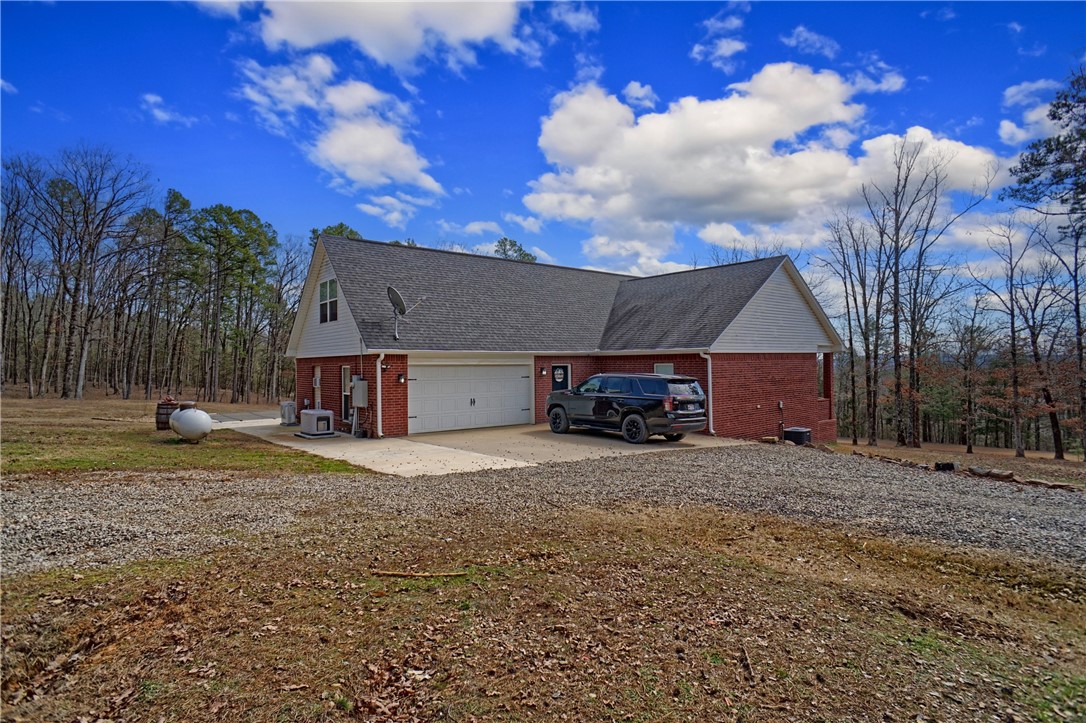 Private setting just north of Dover, AR, this 4-bedroom, 2-bath home boasts an open floor plan with an abundance of natural light. The spacious kitchen is ideal for preparing meals and hosting guests. Relax in the master suite, featuring a jacuzzi tub and an enormous walk-in closet for all your storage needs. Outside, the expansive 4-acre property includes a pool and hot tub, offering the perfect space for outdoor relaxation. With its combination of comfort, convenience, and luxury, this property is the perfect place to call home.