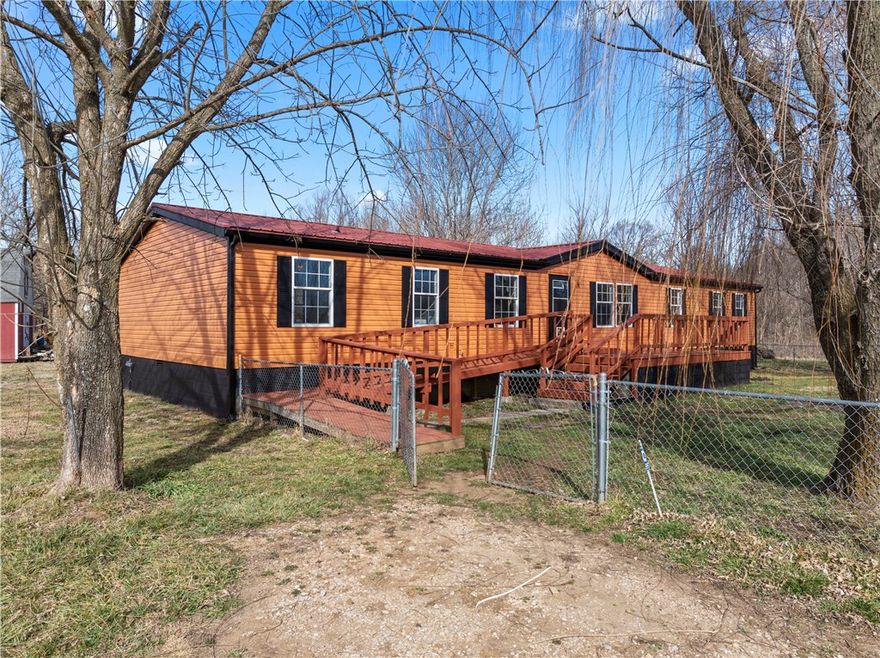 Spacious 4BR/2BA manufactured home with approximately 2,100 sq. ft. situated on 2.25 acres. Features include a large primary suite with walk-in closet, open living areas, and two decks ideal for entertaining or enjoying the outdoors. Outbuilding conveys for added storage or workshop potential. A great opportunity for space and privacy!