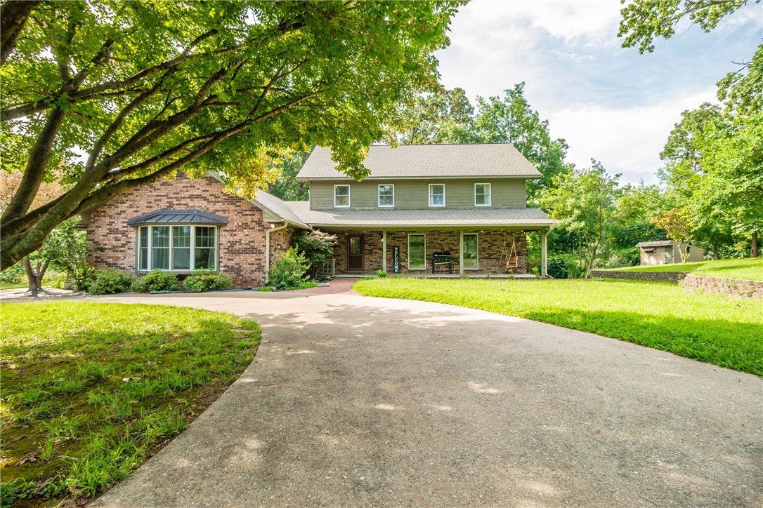 Welcome to 3168 Ozark Acres Drive, a rare 3.41 acre estate located minutes away from all the area favorites. A dreamy, tree-lined drive leads to the southern living style home with a welcoming front porch overlooking picturesque equestrian farmland. The 3,701 sf home features wide plank hardwood flooring, custom millwork, wood windows & doors filtering in natural light, updated lighting, & gorgeous property views from every room. The main level features two living areas, formal dining room with wainscoting, a charming kitchen reflecting a true farmhouse style, spacious utility/mudroom, & a bonus recreation room. The second level hosts the primary ensuite with 3 additional bedrooms and a full bath, while the third level offers a large bonus room with a 5th bedroom & bathroom. Step outside to an expansive deck, fenced-in garden area, & 4-stall horse barn with electricity, Dutch stall doors, tack storage area, groom room & wash stall. This home offers an unmatched lifestyle for the whole family! Property sold As Is.